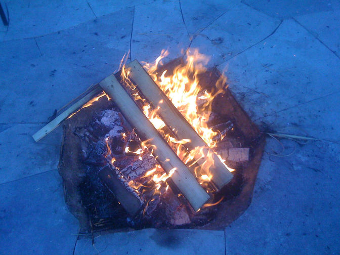 Fire pit embedded in flagstone patio. A natural stone patio project by the London Ontario based O'Connor Stone & Landscape.