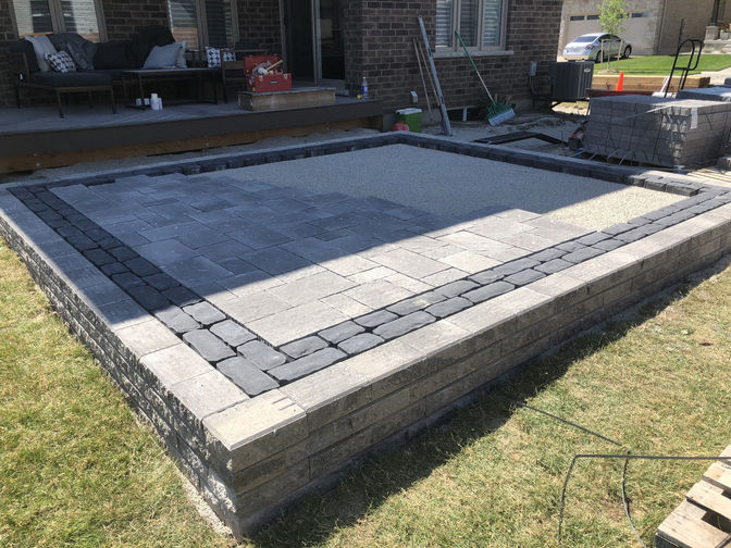 Raised paver patio with border. A raised patio project by O'Connor Stone & Landscape
