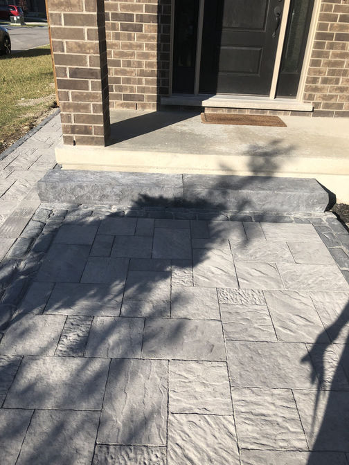 Faux stone steps at front entry. A project by the London Ontario based O'Connor Stone & Landscape