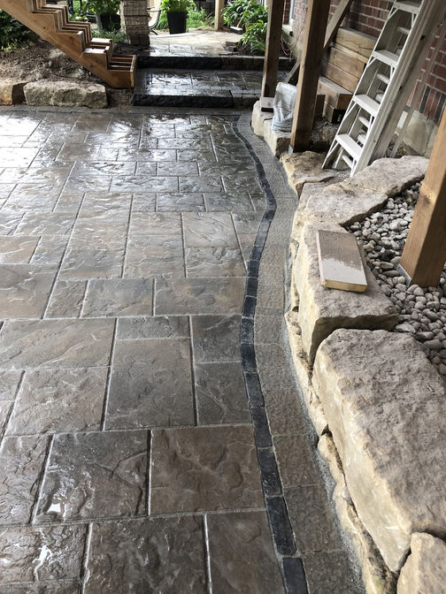 Paver patio with custom border. A project by O'Connor Stone & Landscape, London Ontario based contractor.
