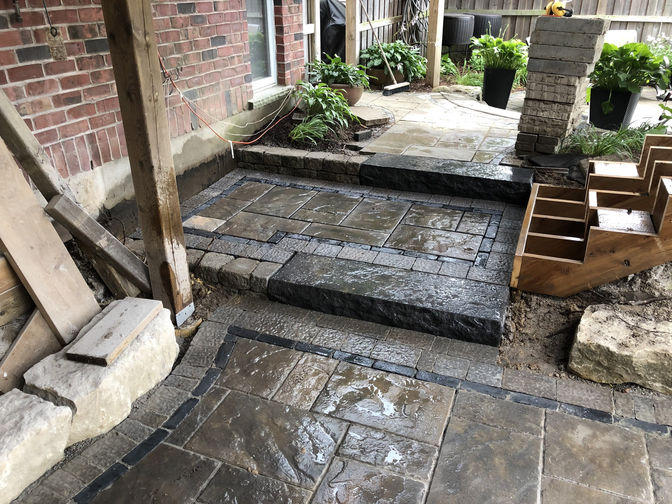 Paver patio with custom border and step. A patio project by O'Connor Stone & Landscape, London Ontario based contractor.