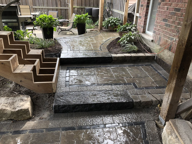 Faux stone steps from walkway to landing to patio. Stone steps or faux stone steps project by O'Connor Stone & Landscape