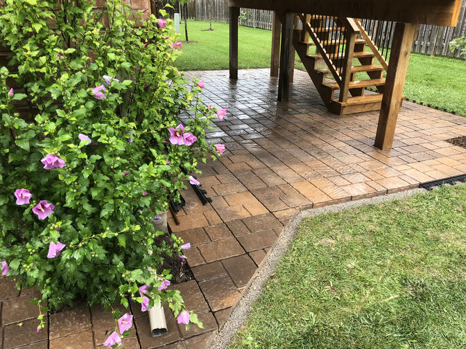 Interlocking Paver Patio Under Deck. A paver patio project in London Ontario region by O'Connor Stone & Landscape.
