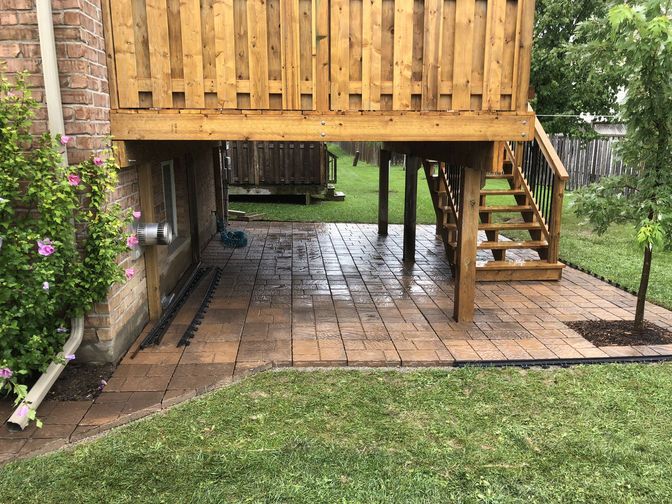Interlocking Paver Patio Under Deck. A paver patio project by O'Connor Stone & Landscape.