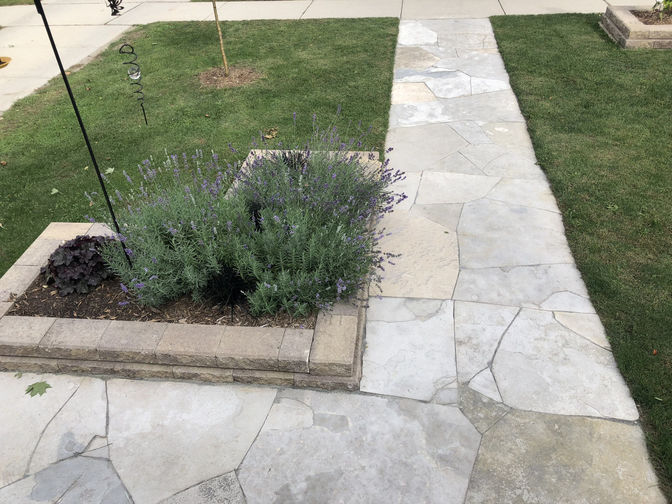 Custom Cut Natural Flagstone Walkway and Raised Flower Bed in London Ontario by O'Connor Stone & Landscape