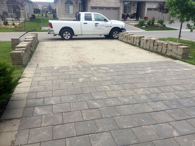 Driveway level and paver relay. An interlocking brick paver relay project in London Ontario region by O'Connor Stone & Landscape.
