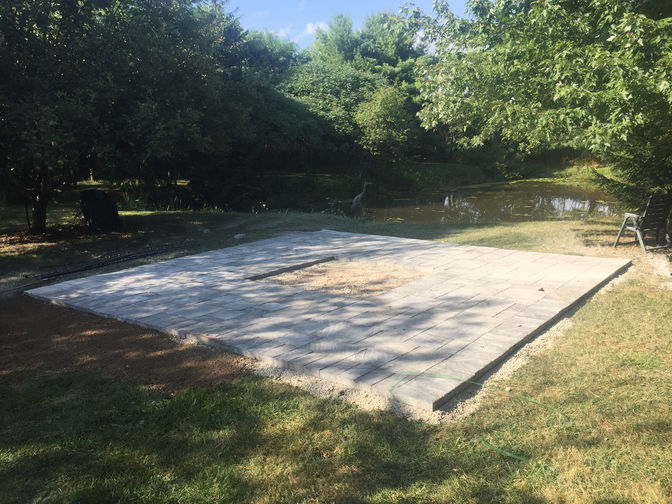 Paver patio with central fire pit. A paver patio project by O'Connor Stone & Landscape