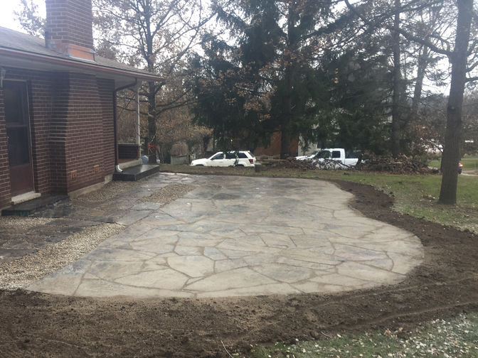 Random granite flagstone patio. Stone or paver patio project in London Ontario region by O'Connor Stone & Landscape.