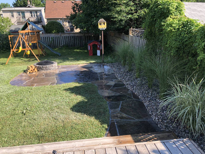 Random flagstone patio with fire pit. A patio project by O'Connor Stone & Landscape, London Ontario based contractor.