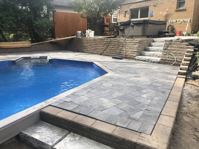 Retaining wall by a pool deck, a project in London Ontario region by O'Connor Stone & Landscape, your local contactor.