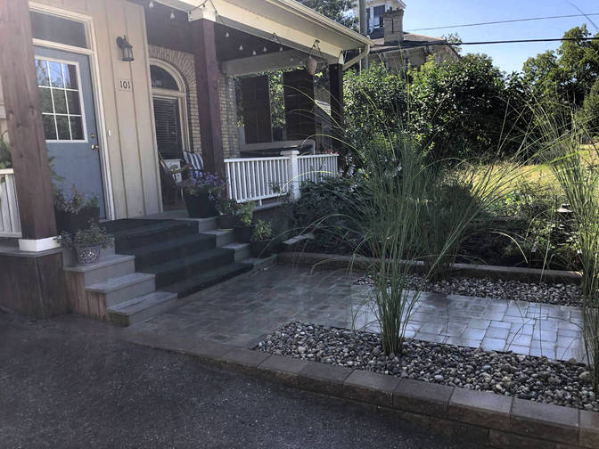 Raised stone paver walkway with landscape feature. A front walkway project in London Ontario region by O'Connor Stone & Landscape.