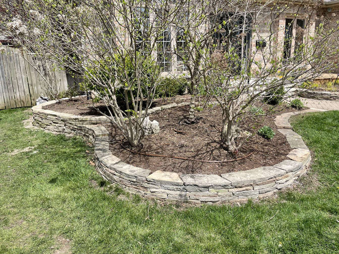 Natural stone retaining wall. A project by the London Ontario based O'Connor Stone & Landscape