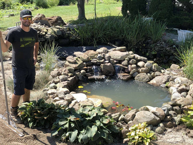 Brian O'Connor and one of his ponds. A water feature project by the London Ontario based O'Connor Stone & Landscape