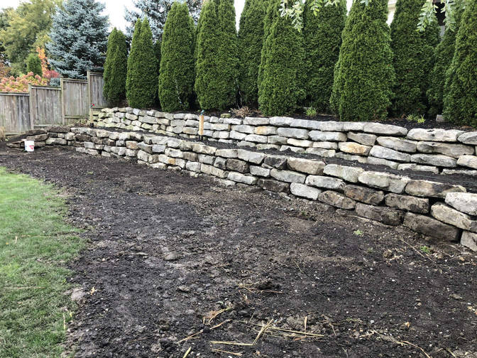 Natural stone retaining wall. A project by the London Ontario based O'Connor Stone & Landscape